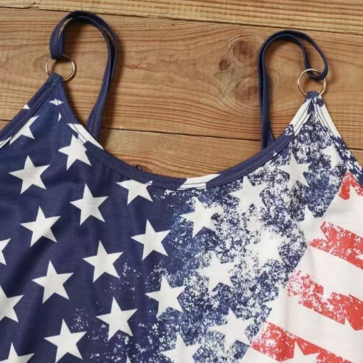 Woman wearing a sleeveless dress with distressed American flag print, taking a mirror selfie with stars on one side and red stripes on the other.