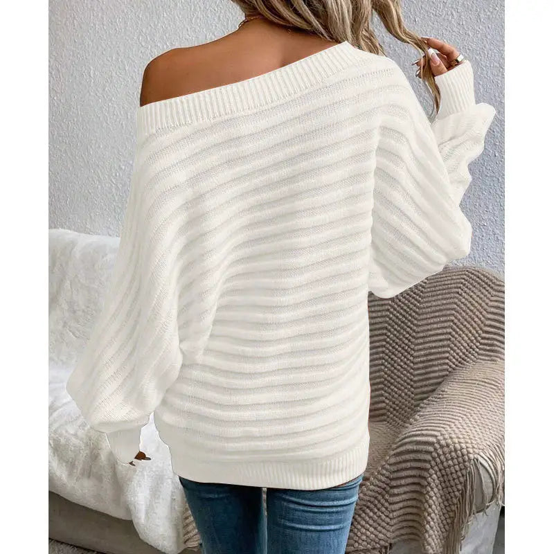 woman wearing a pink off-shoulder ribbed sweater styled with denim for a casual chic look